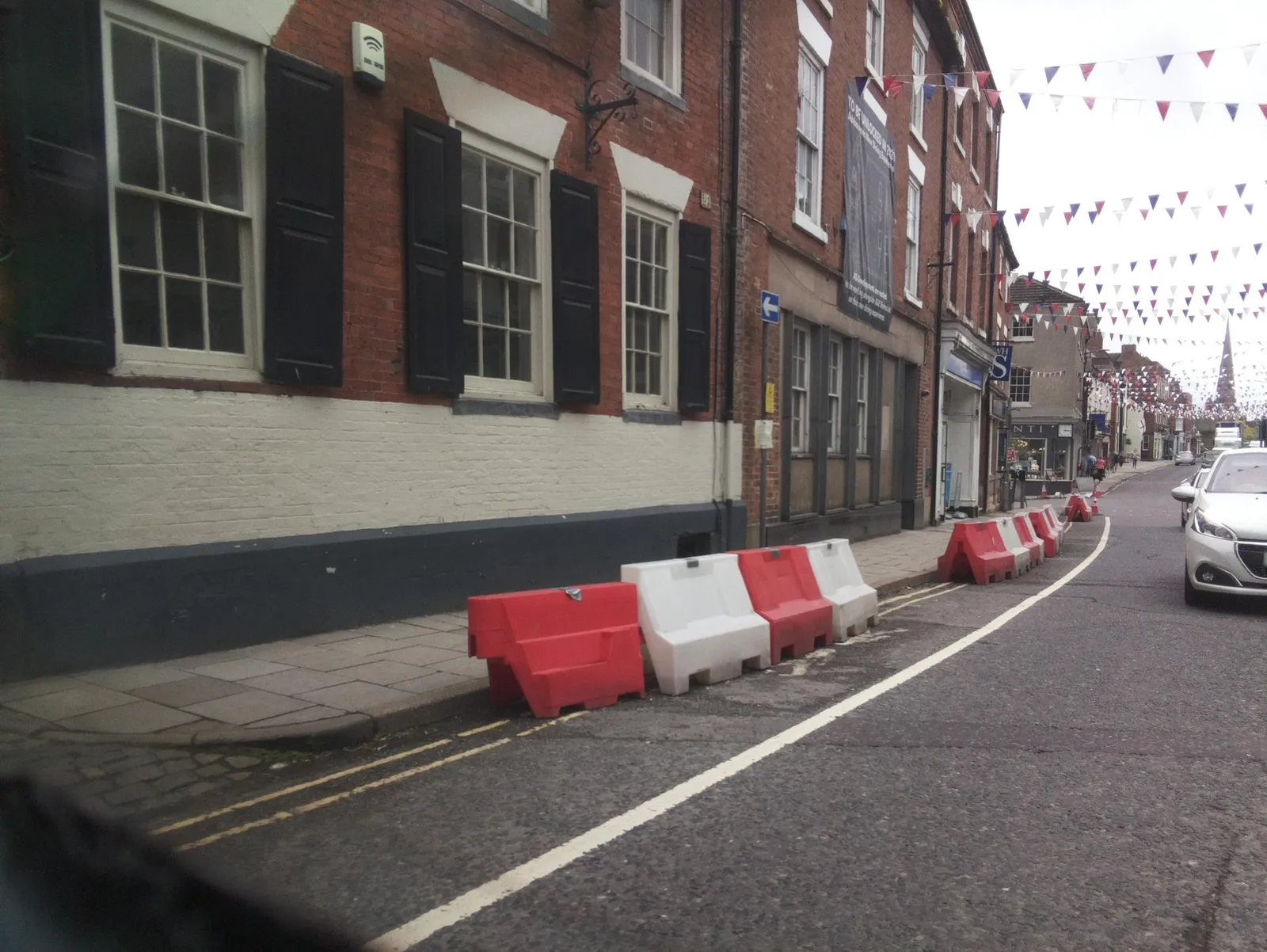 The Green Man And Black's Head Hotel, Attached Inn Sign Bridging Road — street-level view